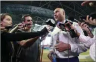  ?? WILFREDO LEE - THE ASSOCIATED PRESS ?? Miami Marlins baseball team CEO Derek Jeter, right, speaks to members of the media inside Marlins Park stadium, Monday, Feb. 11, 2019, in Miami. Jeter is entering his second season as CEO of the Marlins, who remain in the throes of a rebuilding project.