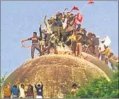  ?? HT FILE ?? Kar sevaks climb the dome of the disputed Babri Masjid while demolishin­g it in 1992.