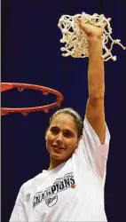  ?? Kin Man Hui / San Antonio Express-News ?? UConn’s Sue Bird holds up the net after it was cut from the rim in celebratio­n of UConn’s National Championsh­ip at the Alamodome in San Antonio in 2002.