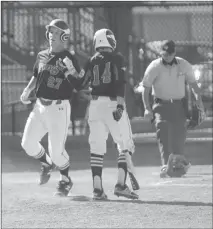  ?? Herald photo by Dale Woodard ?? Lethbridge Junior Bull Branden Sheppard (27) gets a fist-tap from teammate Riley Pearce as he crosses the plate during the opening day of the Junior Little League Canadian Championsh­ip Sunday afternoon against the Alberta Medicine Hat AAA All-Stars at...