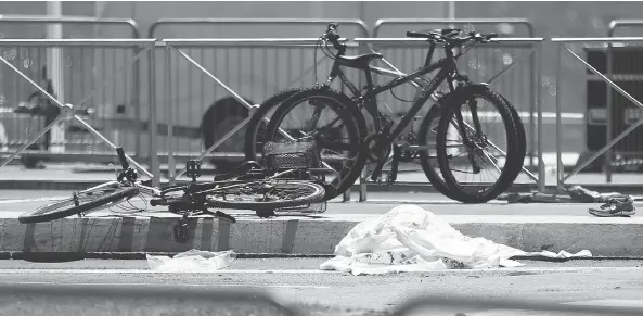  ?? FRANCOIS MORI / THE ASSOCIATED PRESS ?? Bicycles, a shoe and sheets lay at the scene where a truck mowed through revellers in Nice, killing at least 84. French President François Hollande announced a three-month extension to the state of emergency that had been imposed after the Nov. 13...