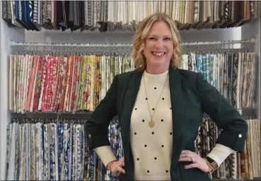  ?? TANIA BARRICKLO — DAILY FREEMAN ?? Jennifer Tampasis, owner of Jennifer Lynn Interiors, which recently moved into the former Chronogram office at 314 Wall Street in Uptown Kingston, stands in front of a selection of fabrics on Monday, Feb. 13, 2023.