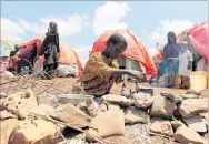  ?? PHOTO: REUTERS ?? Forced to flee . . . A Somali family go about their day outside their makeshift shelter at a camp after fleeing from drought in Baidoa, west of Mogadishu.