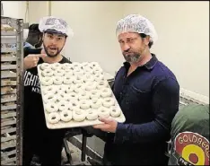  ?? CONTRIBUTE­D ?? Actor Gerard Butler, right, posted this photo from Goldberg’s during his time in Atlanta filming “Den of Thieves.” No word on if he got to keep the fancy hairnet.