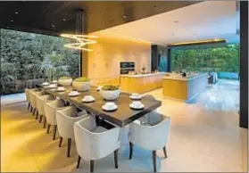  ??  ?? WITH A two-island chef ’s kitchen inside plus an outdoor kitchen, the modern home is perfect for entertaini­ng.