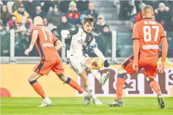  ?? — AFP Photo ?? Juventus’ forward Paulo Dybala (centre) shoots to score his team’s third goal during the Italian Cup (Coppa Italia) round of 16 match against Udinese at the Juventus stadium in Turin.
