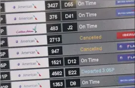  ?? Joe Raedle / Getty Images ?? Asignat the Miami Internatio­nal Airport in Florida shows canceled flights as American Airlines grounds its Boeing 737 Max 8 planes on Wednesday in Miami. The grounding of the 737 Max fleet isn’t expected to have a major impact on the airlines that service the Albany Internatio­nal Airport in Colonie.