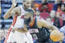  ?? MICHAEL WYKE/AP ?? Rockets guard James Harden tries to get around Heat forward Derrick Jones Jr. during the first half of Monday’s game.