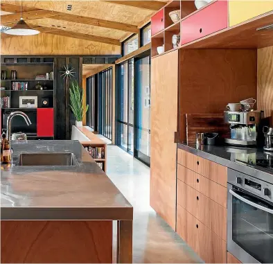  ??  ?? Stainless-steel bench tops make a hardwearin­g contrast to the extensive interior wood in this home by Dorrington Atcheson Architects.