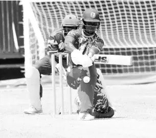  ?? ?? Wolmer’s Boys School’s Jordan Johnson plays a sweep shot on his way to a top score of 86 in his team’s ISSA/TVJ T20 cricket semifinal against St Elizabeth Technical High School at Sabina Park yesterday.