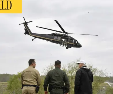 ?? JIM WATSON/AFP/GETTY IMAGES ?? President Donald Trump meets with border patrol agents at the Rio Grande after his visit to Mcallen, Texas, Thursday.
