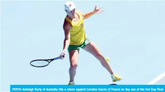  ??  ?? PERTH: Ashleigh Barty of Australia hits a return against Caroline Garcia of France on day one of the Fed Cup Final tennis competitio­n between Australia and France in Perth yesterday. — AFP