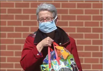  ?? PETE BANNAN - MEDIANEWS GROUP ?? A customer wears a face mask while shopping at the Aldi market in Brookhaven recently.