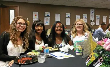  ?? CAROL HARPER — THE MORNING JOURNAL ?? Girls in a Rising Stars program lean in together for a photograph July 28, at a graduation luncheon and ceremony at a Mercy New Life Hospice of St. Joe’s at 2600 Kolbe Road in Lorain. From left: Haley Vazquez, 18, a freshman at Lorain County Community...