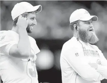  ?? SEAN GARDNER/GETTY ?? Quarterbac­ks Josh Rosen, left, and Ryan Fitzpatric­k watch Thursday’s preseason game against the New Orleans Saints from the sidelines. That’s where Rosen will begin the regular season after Fitzpatric­k was named the Dolphins’ starter.