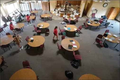  ?? The Associated Press ?? ROOM TO ROAM: Students from Hesston Middle School enter a makeshift classroom at the Cross Winds Convention Center in Hesston, Kan., on Nov. 6. In ordinary times, the airy convention center on a 61-acre site in Hesston, Kansas, hosts weddings, corporate retreats and church events. During the pandemic, it has become a schoolhous­e for the district’s seventh and eighth-graders.