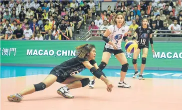  ??  ?? Thailand’s Pimpichaya Kokram dives to dig a spike from Serbia yesterday.