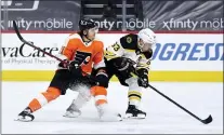  ?? DERIK HAMILTON —THE ASSOCIATED PRESS ?? Boston’s Brad Marchand, right, and the Flyers’ Travis Konecny chase the puck during the third period. The Bruins won 4-2.