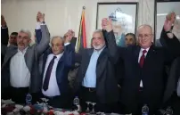  ?? (Ibraheem Abu Mustafa/Reuters) ?? PA PRIME MINISTER Rami Hamdallah (right) joins hands with Hamas political chief Ismail Haniyeh and others yesterday in Gaza.