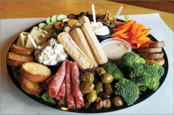  ?? PHOTO BY EMILY RYAN ?? Get your game on and serve a Super Bowl snack board like this one, available at Ron’s Original Bar & Grille.