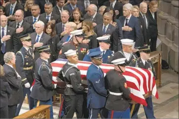  ?? Carolyn Kaster Associated Press ?? GEORGE H.W. BUSH’S casket is carried past President Trump at Washington National Cathedral on Dec. 5.