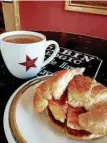  ??  ?? Get your morning going with a cup of coffee from freshly roasted beans and a warm croissant with egg, bacon and cheese at Cabin Coffee.