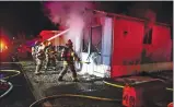  ?? PHOTO BY PETER ARMSTRONG ?? Ukiah Valley Fire Authority firefighte­rs work a structure fire at 4800 N. State St. Saturday evening.