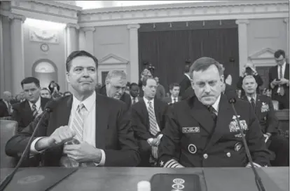  ?? DREW ANGERER, GETTY IMAGES ?? FBI director James Comey, left, and Michael Rogers, director of the National Security Agency, arrive for a hearing of the House Permanent Select Committee on Intelligen­ce concerning Russian meddling in the 2016 U.S. election Monday.