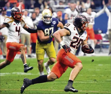  ?? RICK SCUTERI/AP ?? Oklahoma State linebacker Malcolm Rodriguez intercepts a pass against Notre Dame in Saturday’s Fiesta Bowl in Glendale, Arizona. Oklahoma State pulled off the biggest comeback in Fiesta Bowl history, overcoming a 21-point deficit to beat Notre Dame 37-35.