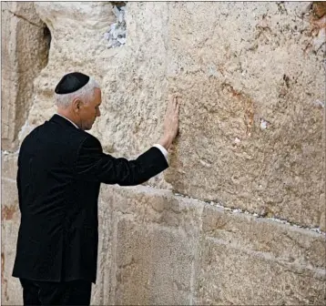  ?? LIOR MIZRAHI/GETTY ?? Vice President Mike Pence touches the Western Wall during a visit Tuesday to the holy site in Jerusalem.