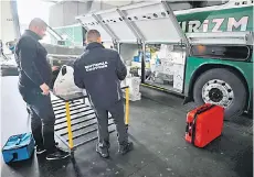  ?? ?? Bulgarian customs officers inspect a bus at border checkpoint.
