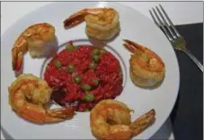  ?? PHOTO BY EMILY RYAN - FOR MEDIANEWS GROUP ?? General Warren serves beet risotto with sweet peas and shrimp.