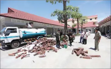  ?? SUPPLIED ?? Authoritie­s seize illegal timber that was being transporte­d in a petrol truck on Friday in Phnom Penh.