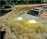  ?? —
AFP ?? A motorist drives a car through a flooded expressway in Brooklyn, New York on Thursday, as record rain brought by Ida swept through the area.