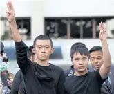  ??  ?? Pro-democracy leaders Tattep Ruangprapa­ikitseree and Panumas Singprom flash the three-fingers salute.