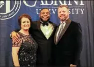 ??  ?? History and Political Science major Treci Butler poses with Cabrini President Donald B. Taylor, PhD, and wife Lechia Taylor at Cabrini’s annual Visionarie­s Gala. Butler provided a reflection on his experience as a senior at the University.