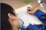  ?? John Moore / Getty Images ?? A student at Stark Elementary School in Stamford works on a lesson last month.