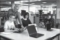  ?? HERALD PHOTO BY STEFFANIE COSTIGAN ?? Shannon McAlorum, Tara Million, Romany Craig and Blair Many Fingers make edits to Wikipedia as part of a Decolonizi­ng Wikipedia: Edit-a-thon workshop on Wednesday at the University of Lethbridge Library.