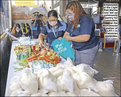  ?? EDD GUMBAN ?? Employees of the Light Rail Manila Corp. set up a community pantry for commuters at the Monumento station of LRT-1 in Caloocan yesterday.