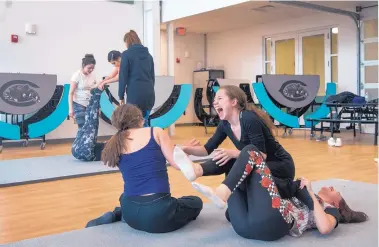  ?? EDDIE MOORE/JOURNAL ?? From left, Jeanette Garcia, 16, Marcella White, 17, and Alyssa Gonzales, 17, bust out laughing after they failed at a move taught at Capital High by teachers from Wise Fool New Mexico.