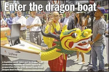  ??  ?? A Buddhist monk takes part in dragon boat awakening ceremony in Times Square in preparatio­n for the 27th annual Hong Kong Dragon Boat Festival.