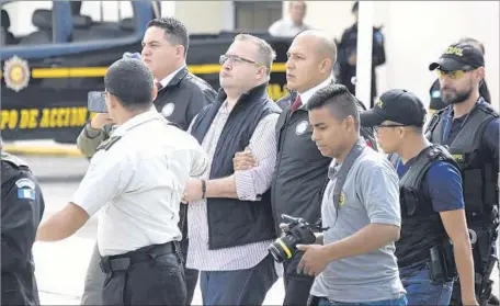  ?? Johan Ordonez AFP/Getty Images ?? JAVIER DUARTE, center, is charged with setting up shell companies to divert millions of dollars for himself and cronies in Veracruz state.