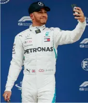  ?? — AP ?? Lewis Hamilton poses for a selfie after taking pole position for the Spanish Grand Prix in Barcelona on Saturday.