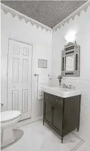  ?? Creators Syndicate photo ?? White bathrooms are easy to work with because the addition of just a bit of color on the walls can make a big difference.