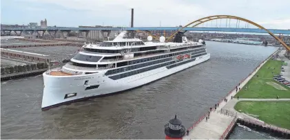  ?? CHELSEY LEWIS AND JAMES NELSON / MILWAUKEE JOURNAL SENTINEL ?? The Viking Octantis passes under the Hoan Bridge in Milwaukee on Friday, May 6. It is the first cruise ship to visit the city since 2019.