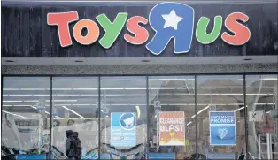  ?? AP PHOTO ?? A person walks near the entrance to a Toys R Us store earlier this year in Wayne, N.J.