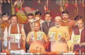  ?? PTI PHOTO ?? Chief minister Yogi Adityanath releases a book on completing 4.5 years of his government at Lok Bhawan in Lucknow, on Sunday. Deputy CMs Dinesh Sharma, K P Maurya and BJP state president Swatantra Dev are also seen.