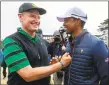  ?? Simon Baker / AFP via Getty Images ?? Internatio­nal Team captain Ernie Els, left, congratula­tes USA team member and captain Tiger Woods after the US team’s win in the Presidents Cup in Melbourne on Sunday.