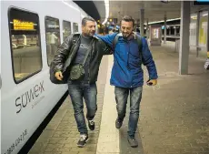  ??  ?? GERMANY On Wednesday, Sept. 16, 2015, Mohammed al-Haj, right, and his friend Dr. Ahmed Naasan embraced each other after their arrival in Saarbrucke­n, western Germany.