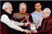  ??  ?? Prime Minister Narendra Modi presents to President Pranab Mukherjee a copy of the book “Various Reports, 4th Volume of Selected Speeches of the President” after its release at Rashtrapat­i Bhavan in New Delhi on Monday.